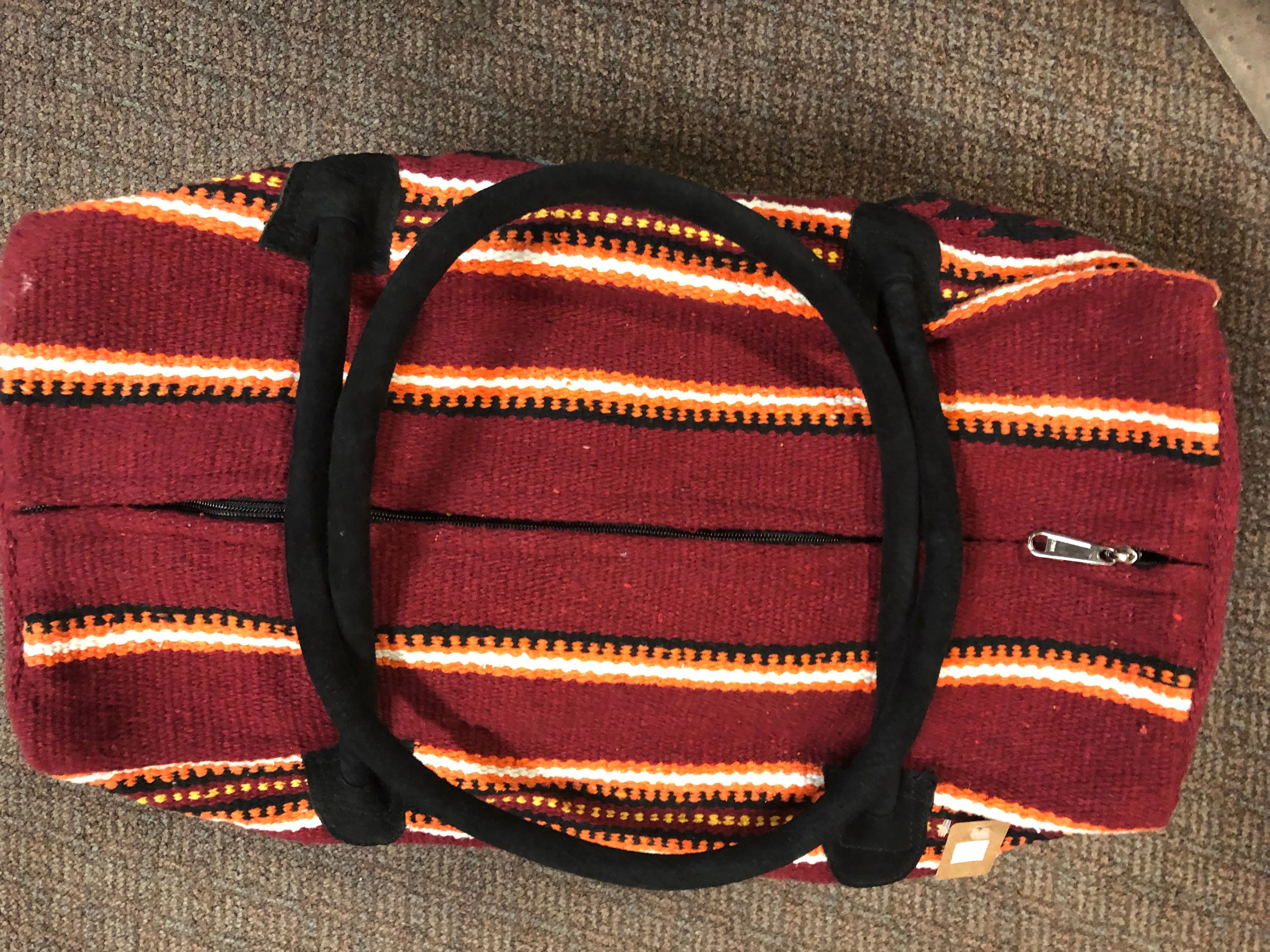 Handwoven recycled acrylic Southwest style weekender bag.  22” x 10” x 12” high.