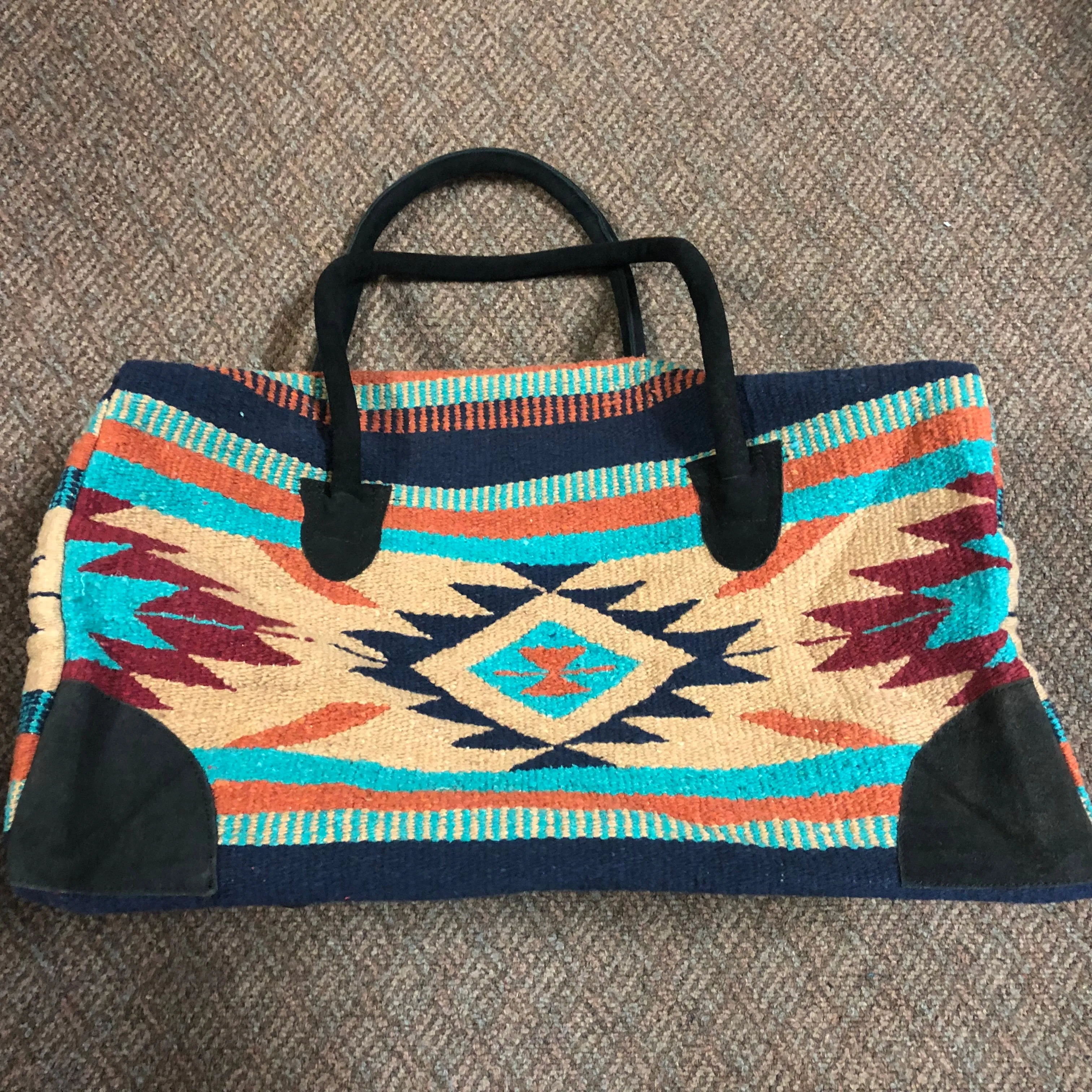 Handwoven recycled acrylic Southwest style weekender bag.  22” x 10” x 12” high.