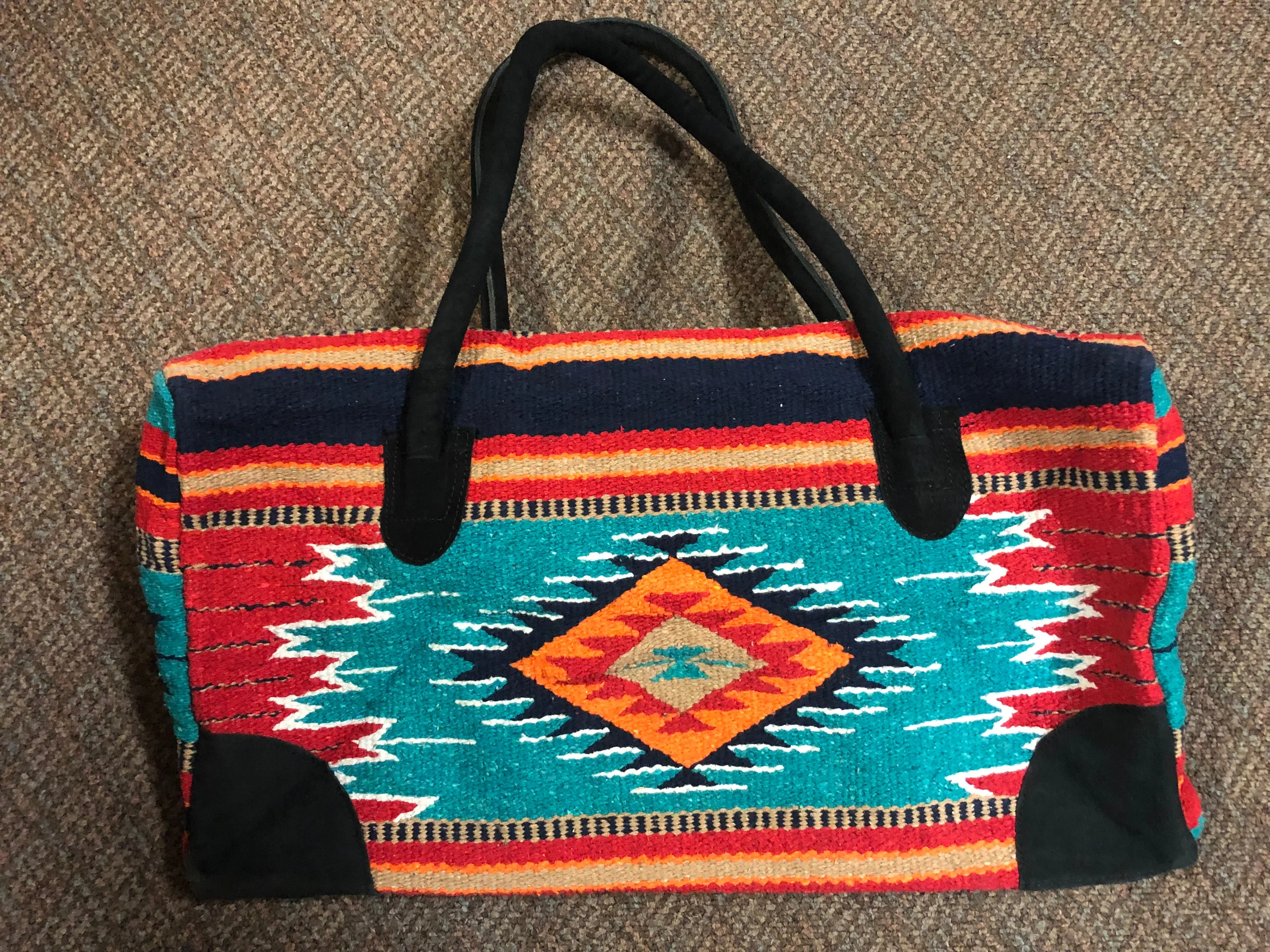 Handwoven recycled acrylic Southwest style weekender bag.  22” x 10” x 12” high.